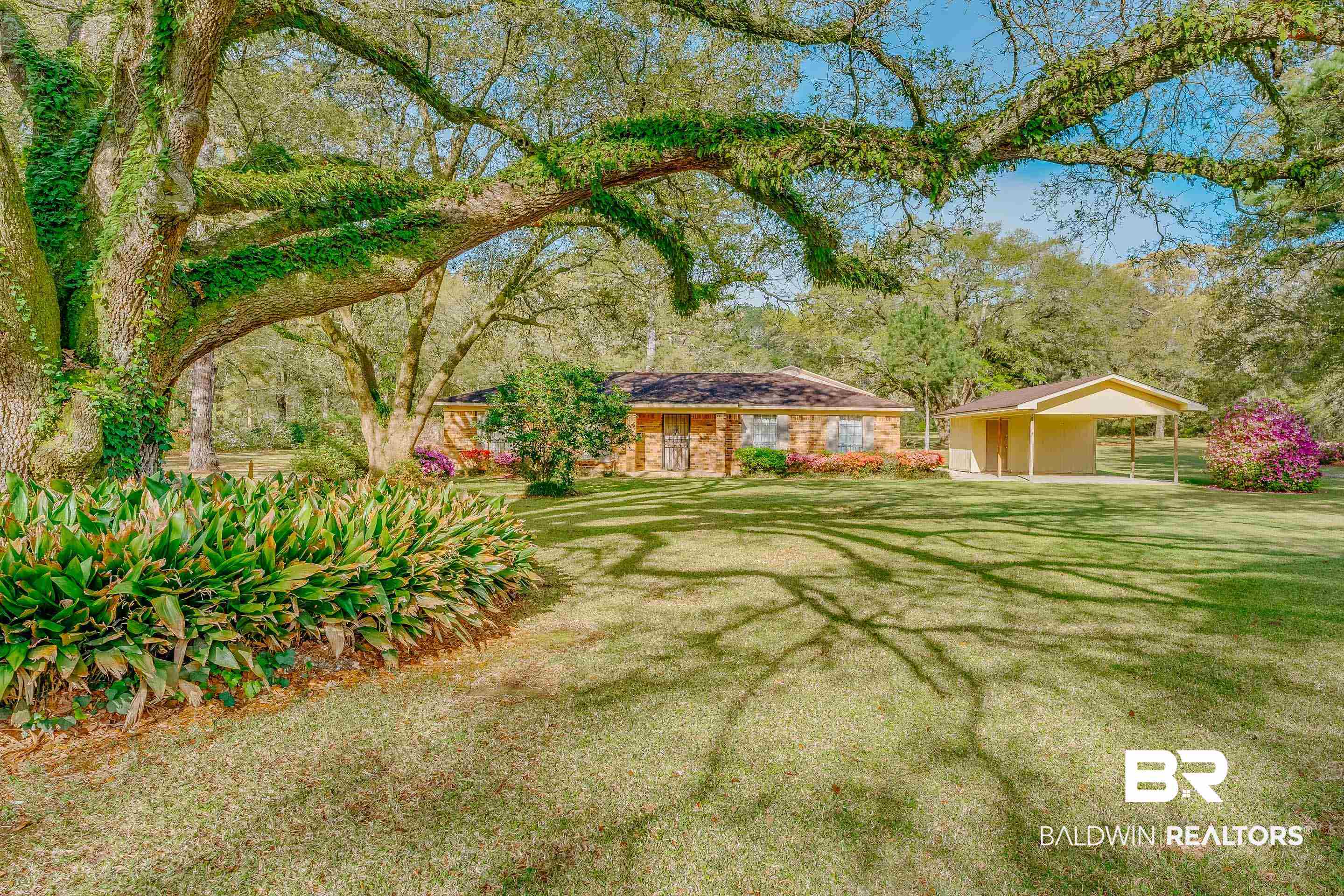 5151 McCrary Road Semmes, AL 36575 - Photo 13 of 62 View of green lawn with a detached carport