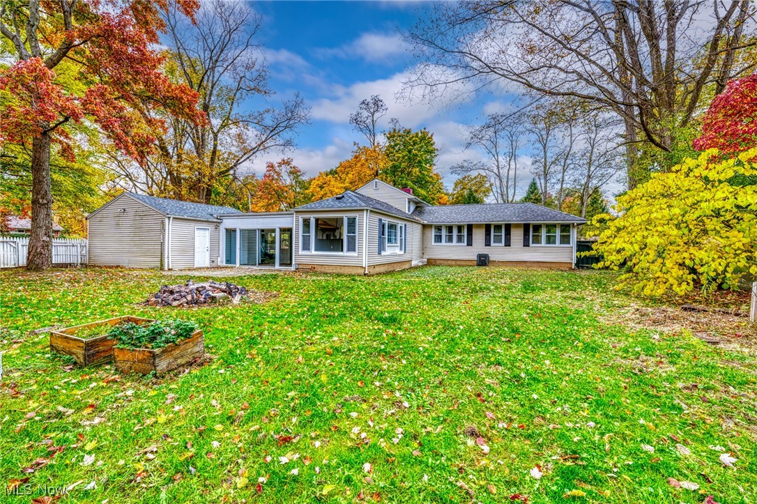 Rear view of property featuring a lawn