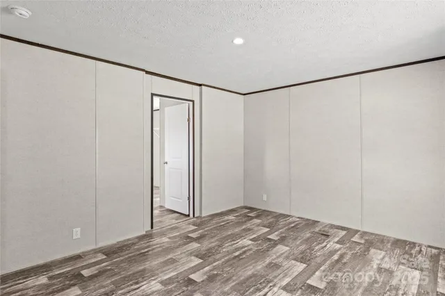 a view of a room with wooden floor