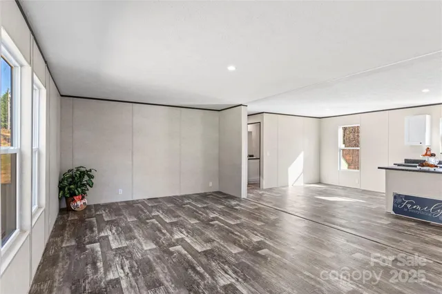a view of a room with wooden floor and potted plants