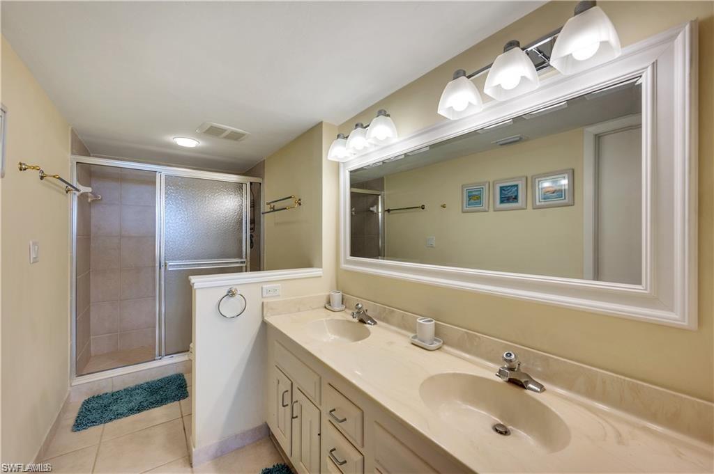 17 Bluebill Avenue, Unit 904 Naples, FL 34108 - Photo 16 of 20 a bathroom with a double vanity sink mirror and double