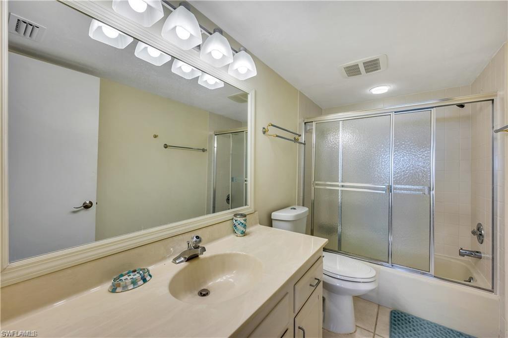 17 Bluebill Avenue, Unit 904 Naples, FL 34108 - Photo 17 of 20 a bathroom with a sink a toilet and shower