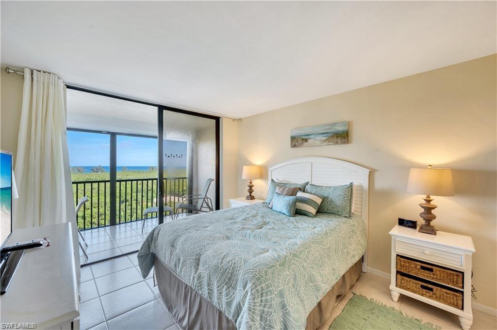 17 Bluebill Avenue, Unit 904 Naples, FL 34108 - Photo 10 of 20 a bedroom with a bed and a view of bedroom
