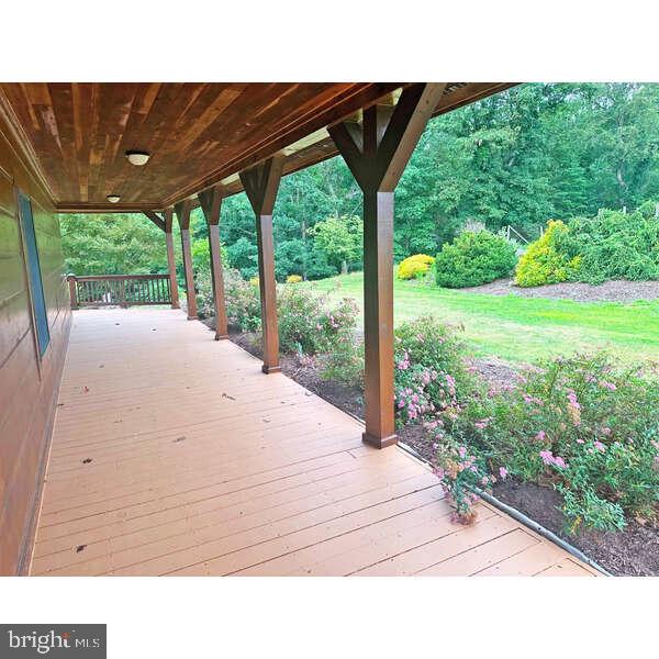 495 Ritchey Road Everett, PA 15537 - Photo 21 of 69 Serene porch with lush garden views.