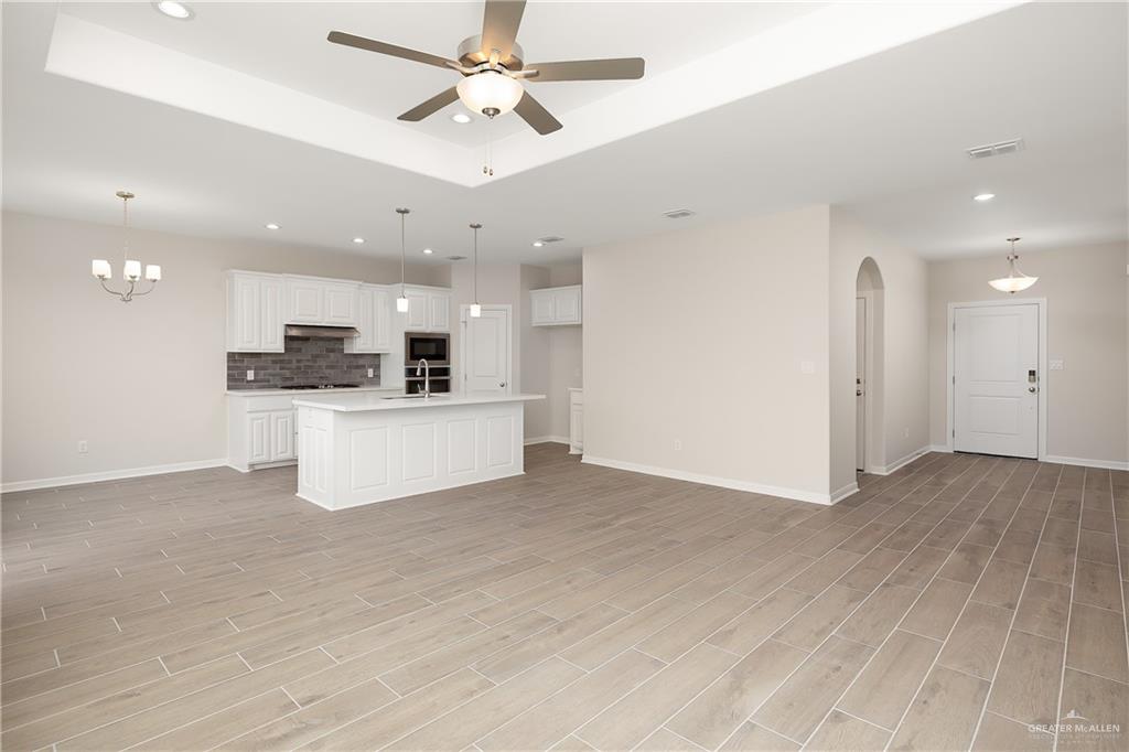 6600 Anaqua Loop McAllen, TX 78504 - Photo 3 of 16 a view of a kitchen with a sink and a microwave