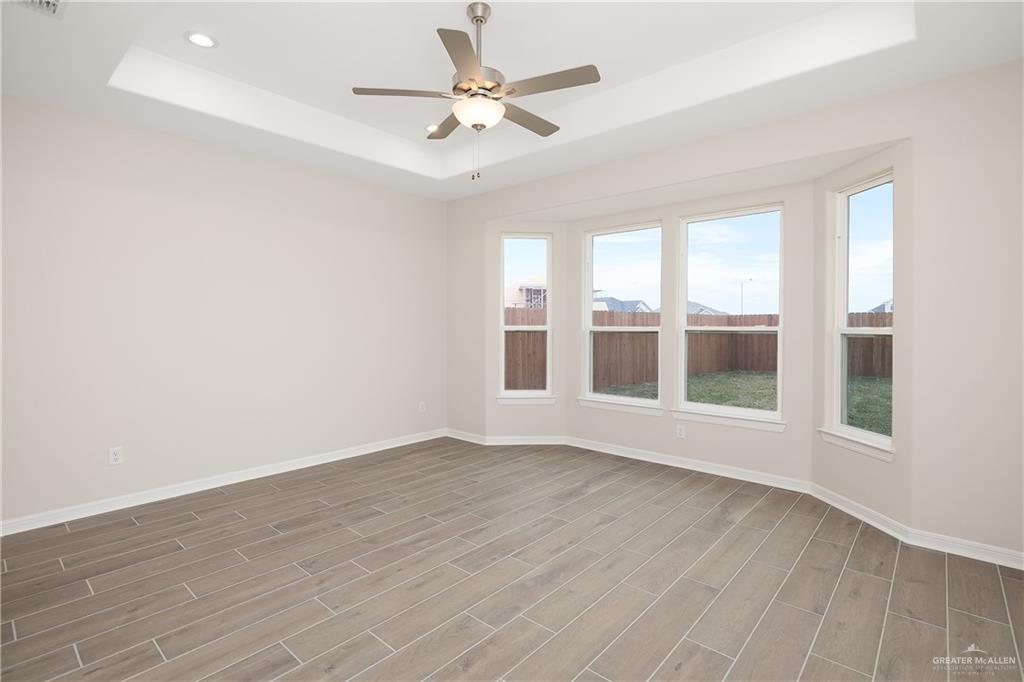 6600 Anaqua Loop McAllen, TX 78504 - Photo 6 of 16 wooden floor in an empty room with a window