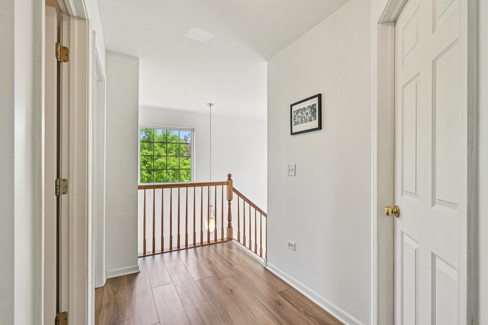 2145 Sunrise Circle Aurora, IL 60503 - Photo 16 of 29 a view of a hallway with wooden floor and a bathroom