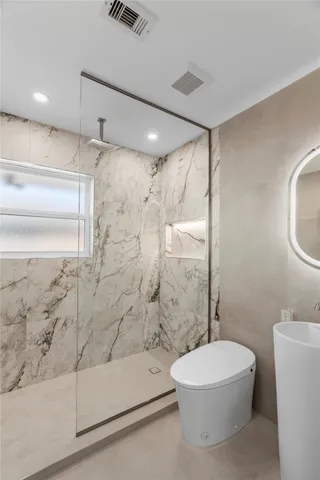 a view of an empty room with window and cabinet