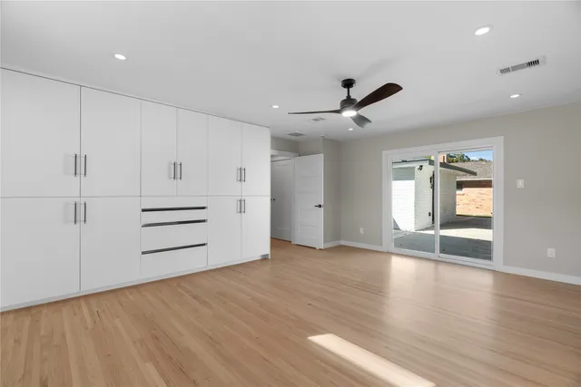 a bathroom with a double vanity sink mirror and bathtub