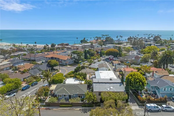 an aerial view of residential building and ocean