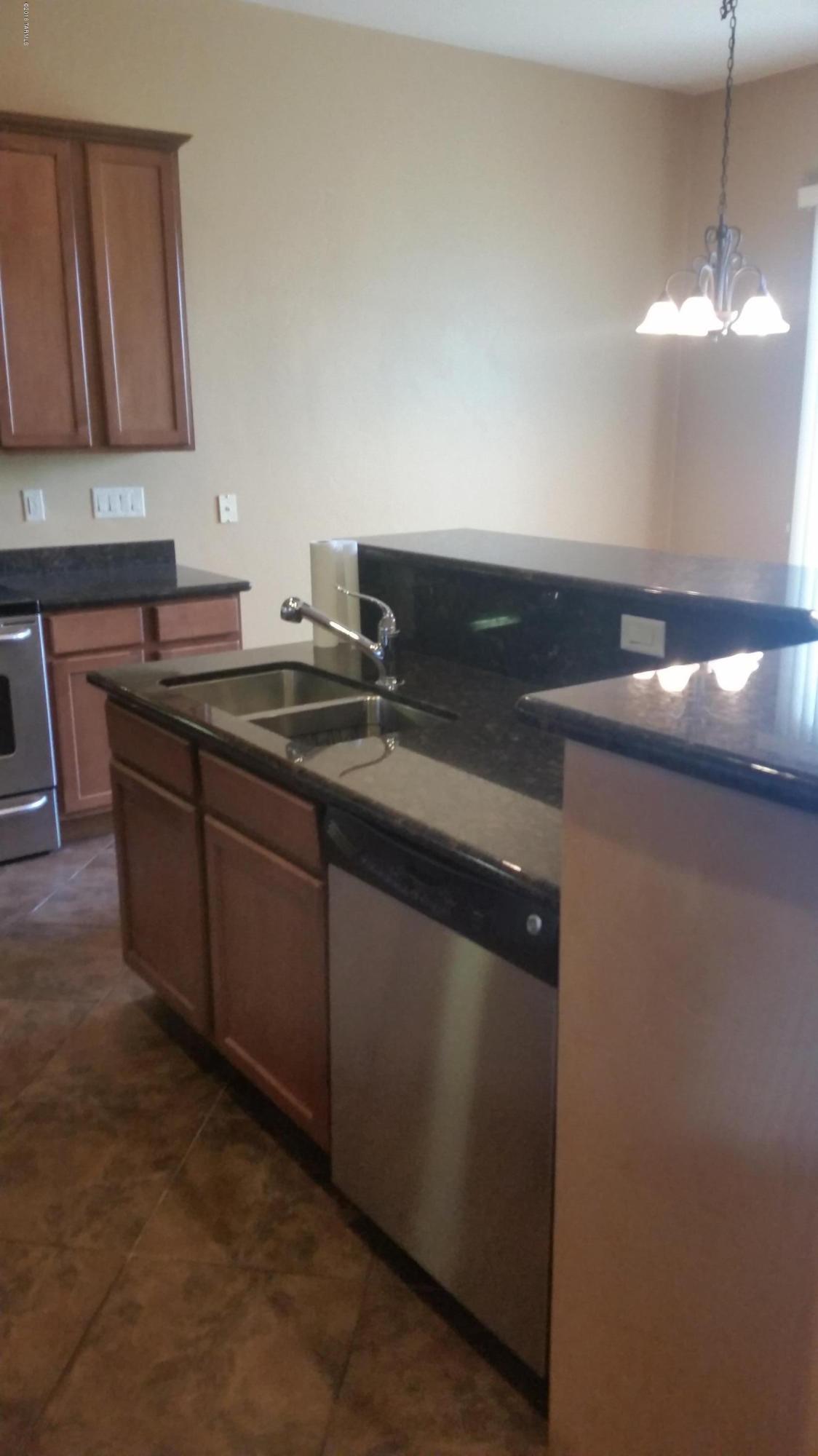 478 East Cedarvale Road Tucson, AZ 85704 - Photo 7 of 39 a kitchen with a sink and cabinets