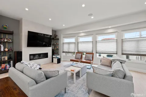a living room with fireplace furniture and a flat screen tv