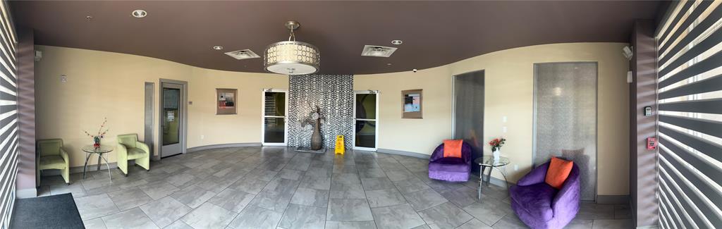 1100 West Trinity Mills Road, Unit 3015 Carrollton, TX 75006 - Photo 3 of 14 a view of an entryway with wooden floor and chandelier