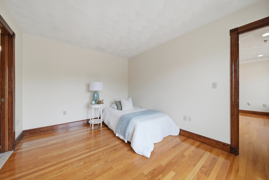 131 Range Heights Road Lynn, MA 01904 - Photo 15 of 36 a bedroom with a bed and wooden floor