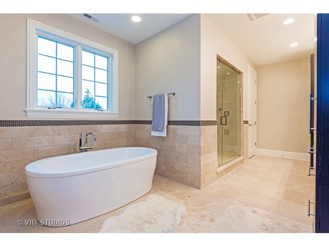 1949 Beechnut Road Northbrook, IL 60062 - Photo 17 of 25 a bathroom with a bathtub and a shower