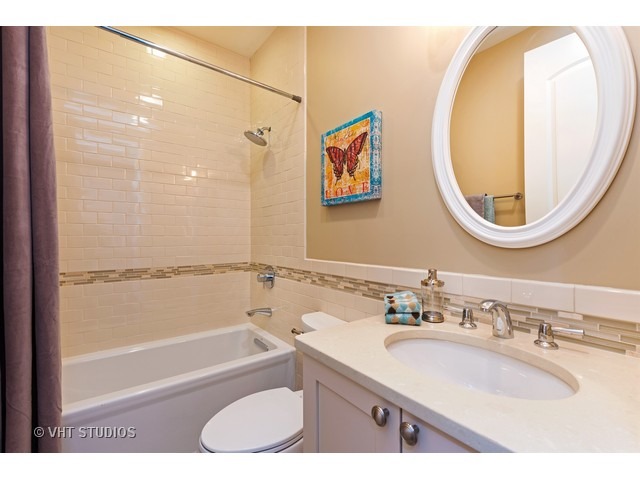 1949 Beechnut Road Northbrook, IL 60062 - Photo 22 of 25 a bathroom with a granite countertop sink mirror toilet and bathtub