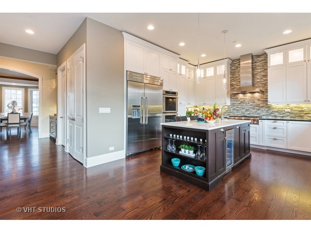 1949 Beechnut Road Northbrook, IL 60062 - Photo 6 of 25 a kitchen with stainless steel appliances granite countertop a refrigerator a stove and a wooden floors
