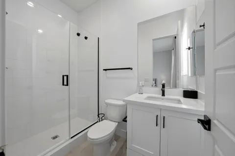 a bathroom with a sink toilet and shower