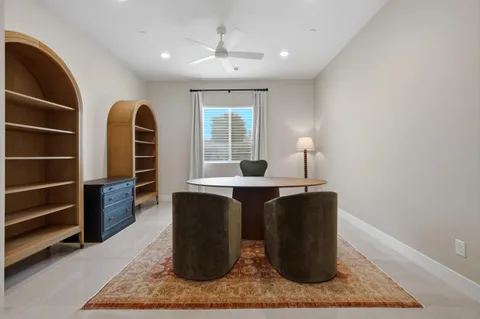 a dining room with a table and chairs