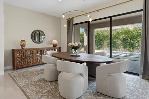 a dining room with furniture and window