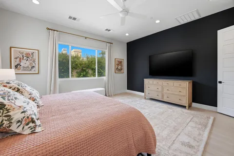 a bedroom with a bed and a flat screen tv