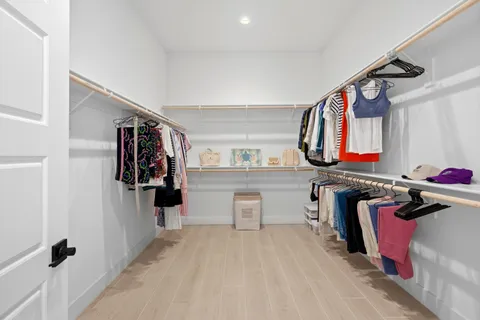 a hallway with white cabinets and window