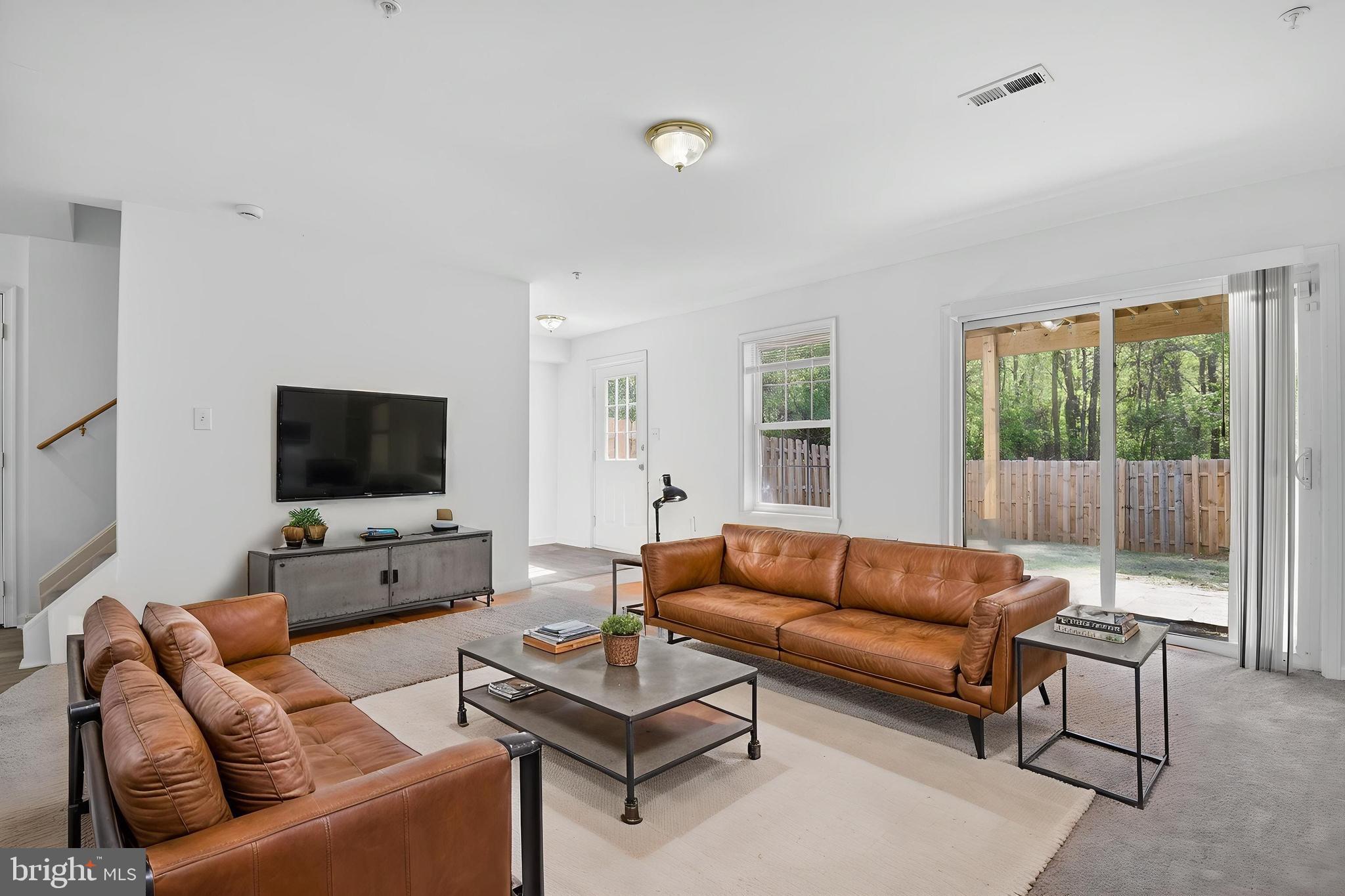 280 Brock Bridge Road Laurel, MD 20724 - Photo 2 of 22 a living room with furniture and a flat screen tv