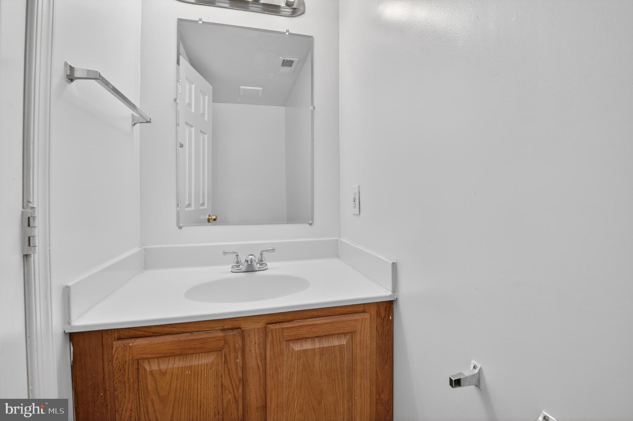 280 Brock Bridge Road Laurel, MD 20724 - Photo 3 of 22 a bathroom with a sink and a mirror