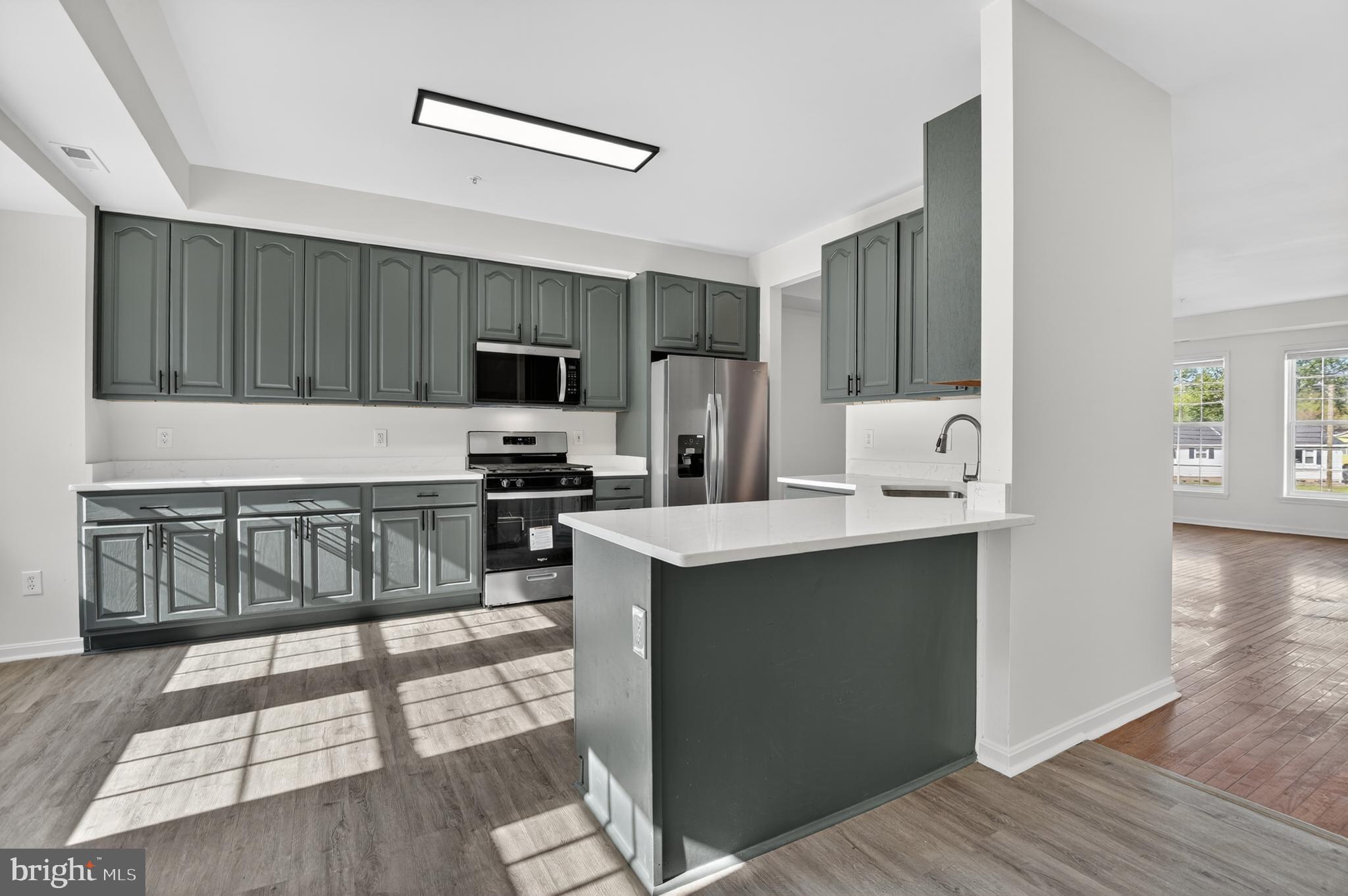 280 Brock Bridge Road Laurel, MD 20724 - Photo 6 of 22 a kitchen with a sink cabinets and wooden floor