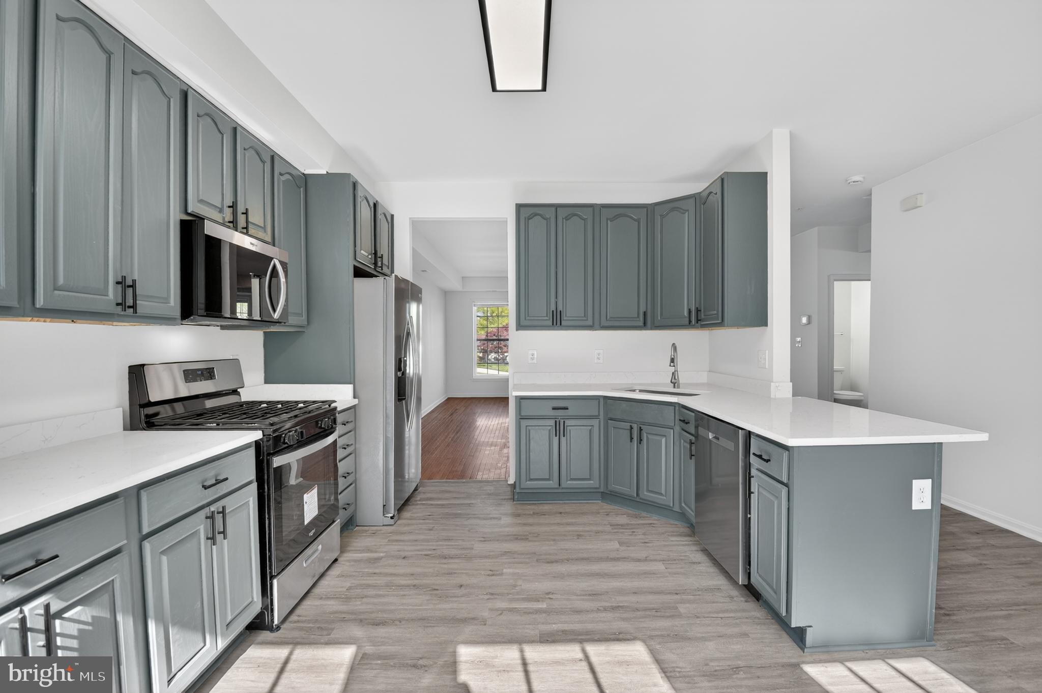280 Brock Bridge Road Laurel, MD 20724 - Photo 9 of 22 a kitchen with stainless steel appliances a stove sink microwave and cabinets