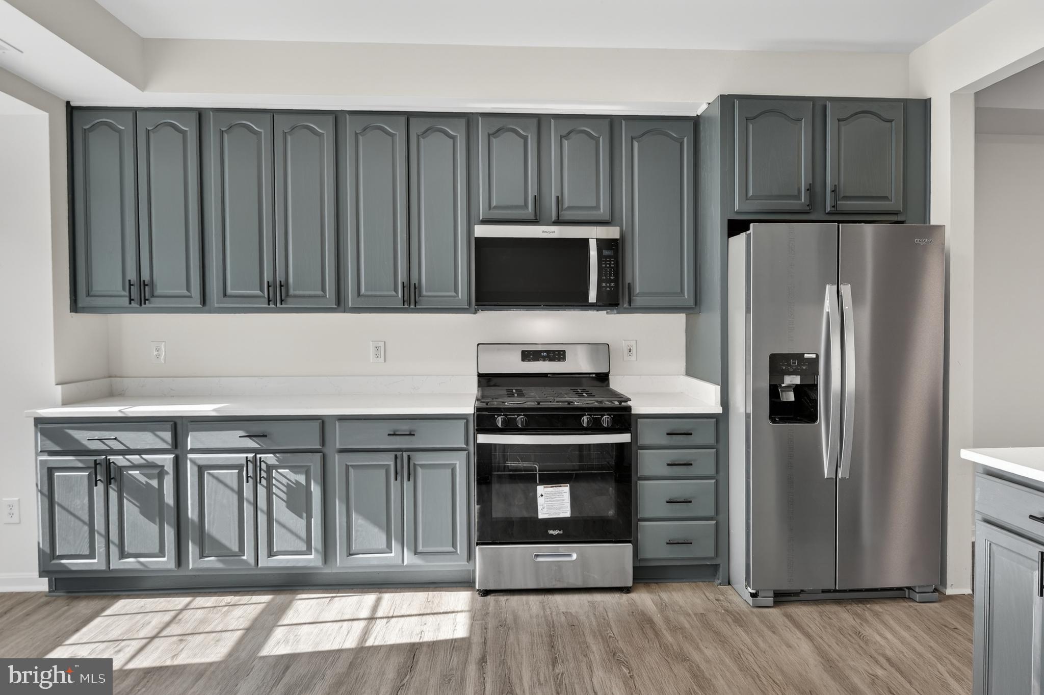 280 Brock Bridge Road Laurel, MD 20724 - Photo 10 of 22 a kitchen with wooden cabinets and stainless steel appliances