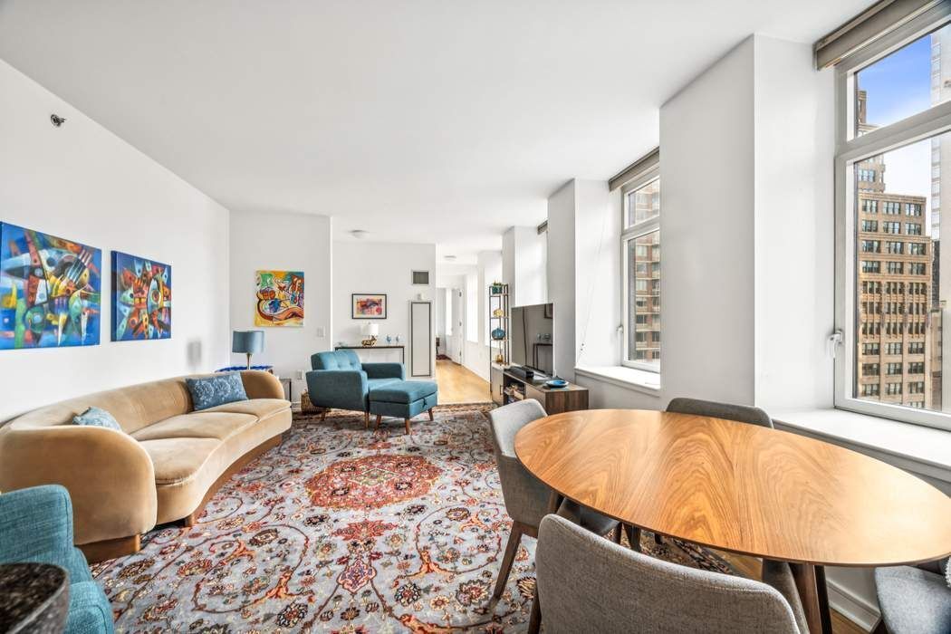 11 East 29th Street, Unit 16B Manhattan, NY 10016 - Photo 2 of 6 a living room with furniture and a large window
