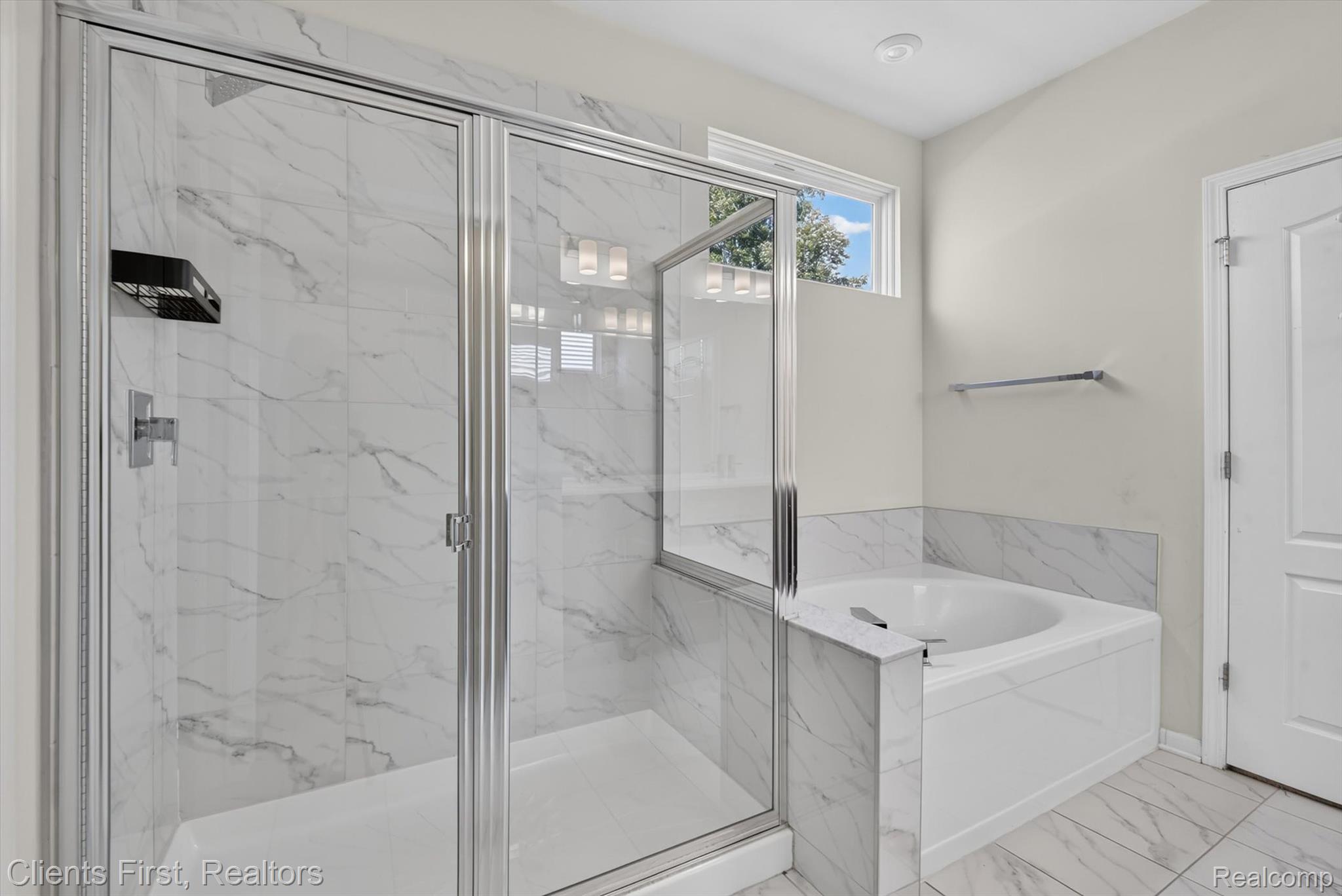 4699 Bingham Road Canton, MI 48188 - Photo 20 of 47 Shower enclosure with clear glass door and white marble-look tile surround