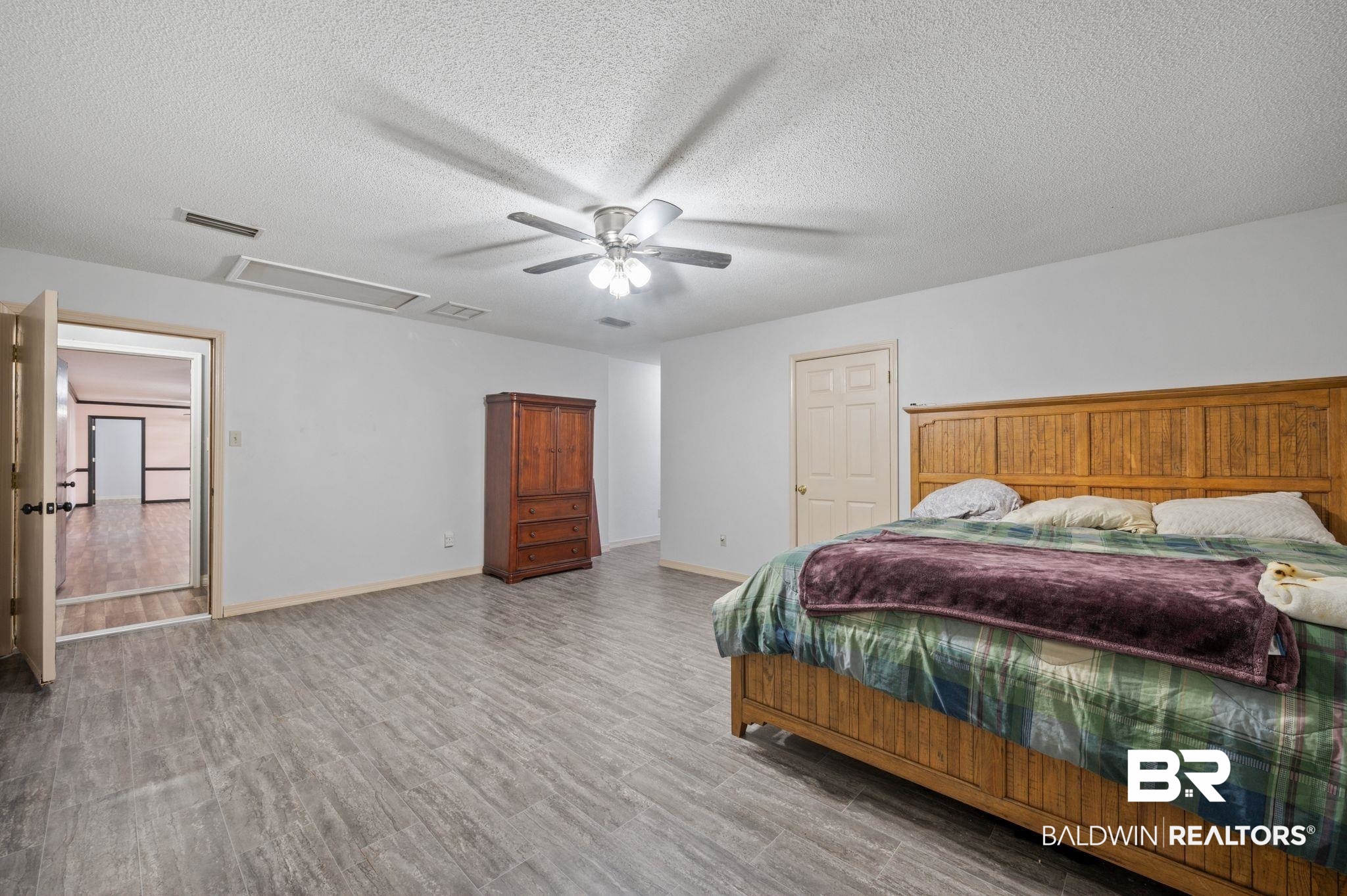 100 Orleans Way Daphne, AL 36526 - Photo 19 of 31 Bedroom with ceiling fan, light wood-type flooring, and a textured ceiling