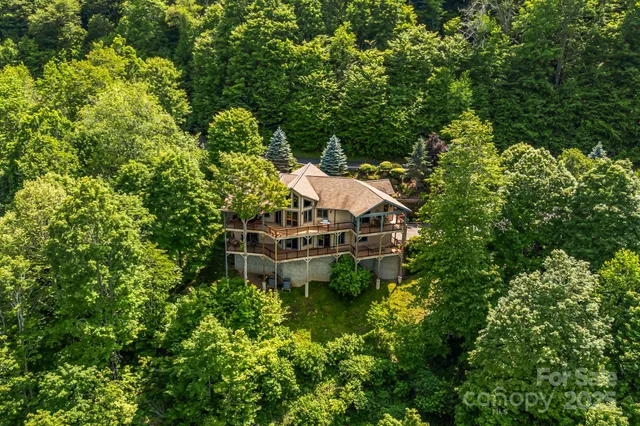 a living room with fireplace furniture and a floor to ceiling window