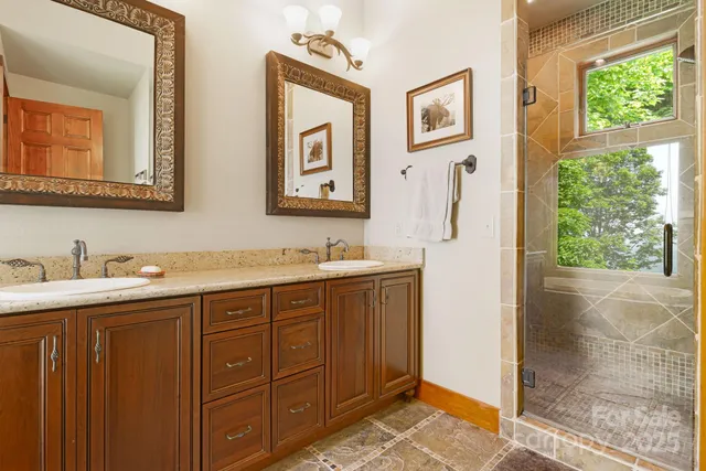a bathroom with a granite countertop sink mirror and double