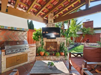 a view of a chair and table in backyard of the house