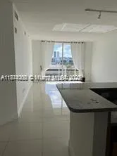 a view of a kitchen with a sink and a microwave