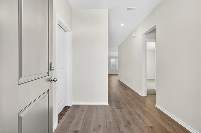 a view of hallway with wooden floor