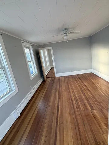 wooden floor in an empty room with a window