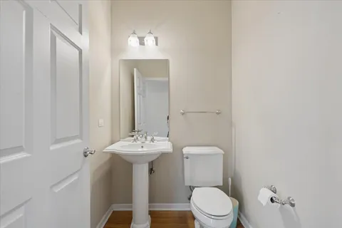a bathroom with a sink a toilet and mirror