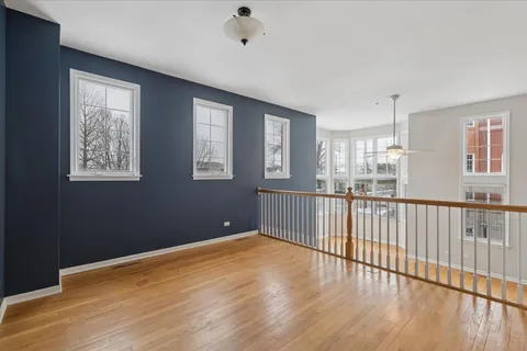 a view of a room with wooden floor and windows