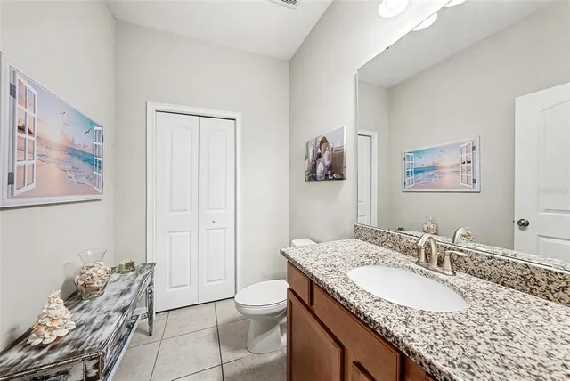 a bathroom with a granite countertop sink and a mirror