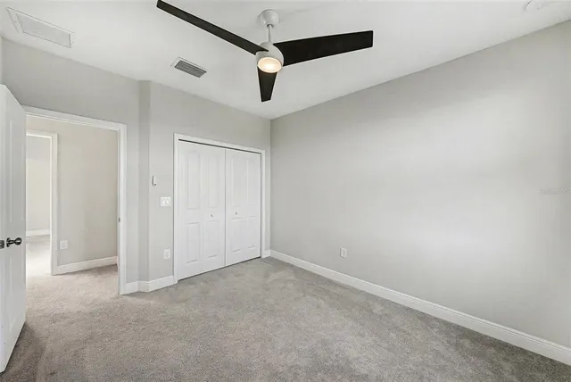 an empty room with a ceiling fan