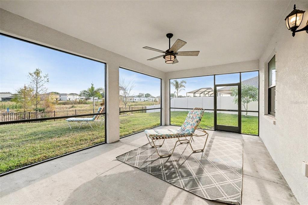 13638 Moosehead Circle Hudson, FL 34669 - Photo 22 of 24 a living room filled with furniture and a floor to ceiling window