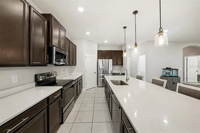 a kitchen with stainless steel appliances a sink stove and refrigerator