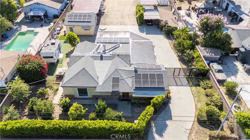 an aerial view of a house with a yard