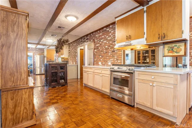 a kitchen with stainless steel appliances a stove a sink and a refrigerator
