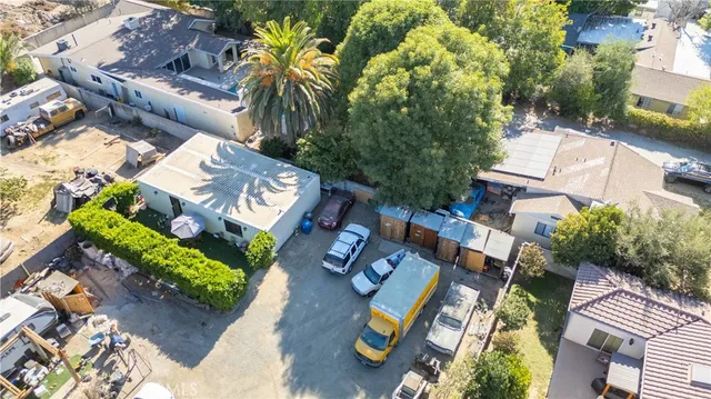 an aerial view of a residential houses with yard