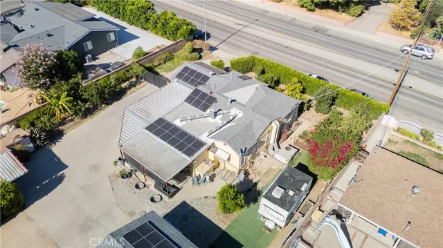 an aerial view of a house with a yard
